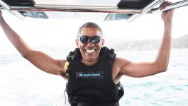 Former U.S. President Barack Obama sits on a boat during a kite surfing outing with British businessman Richard Branson during his holiday on Branson's Moskito island, in the British Virgin Islands, in a picture handed out by Virgin